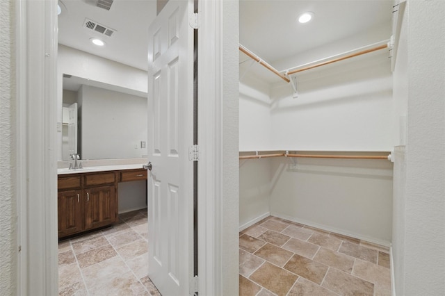 5518 Oak Branch Dr, Arlington, TX 76016 - spacious closet featuring stone finish flooring and a sink