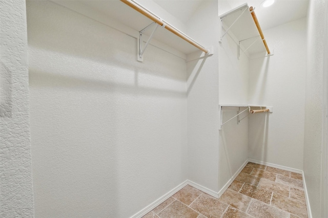5518 Oak Branch Dr, Arlington, TX 76016 - spacious closet featuring stone tile flooring