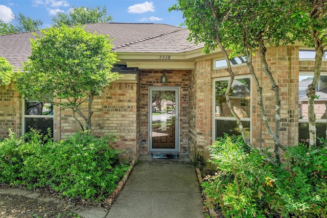 5518 Oak Branch Dr, Arlington, TX 76016 - view of exterior entry with brick siding and a shingled roof