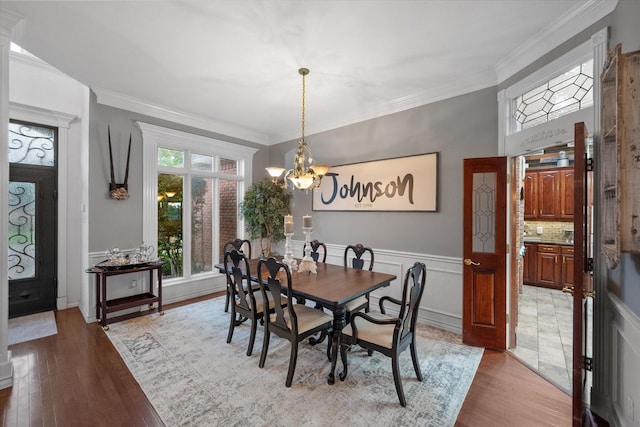 719 Morningside Dr, Mansfield, TX 76063 - dining room featuring a chandelier, light wood finished floors, crown molding, and wainscoting