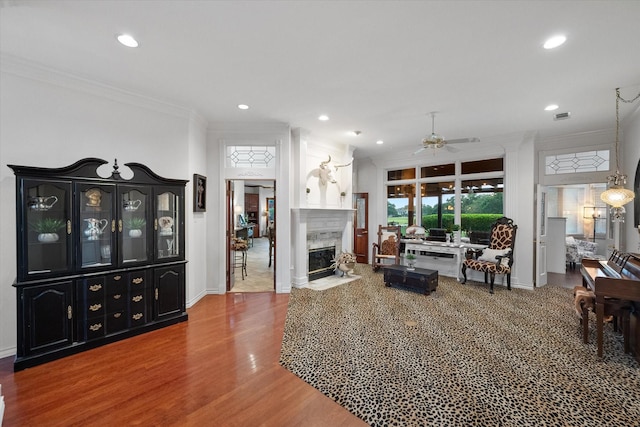 719 Morningside Dr, Mansfield, TX 76063 - living room with ceiling fan, crown molding, wood finished floors, recessed lighting, and a fireplace with flush hearth