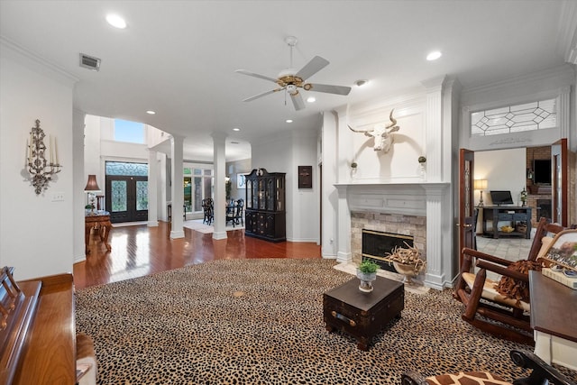 719 Morningside Dr, Mansfield, TX 76063 - living area featuring ornate columns, a ceiling fan, wood finished floors, a fireplace with flush hearth, and crown molding