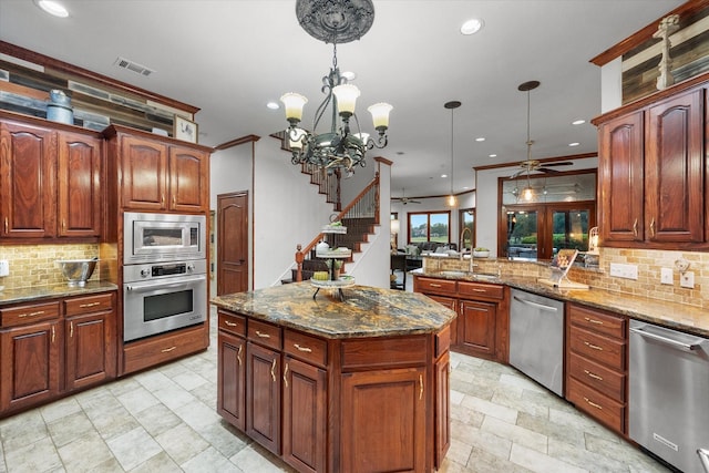 719 Morningside Dr, Mansfield, TX 76063 - kitchen featuring appliances with stainless steel finishes, a ceiling fan, backsplash, recessed lighting, and a peninsula