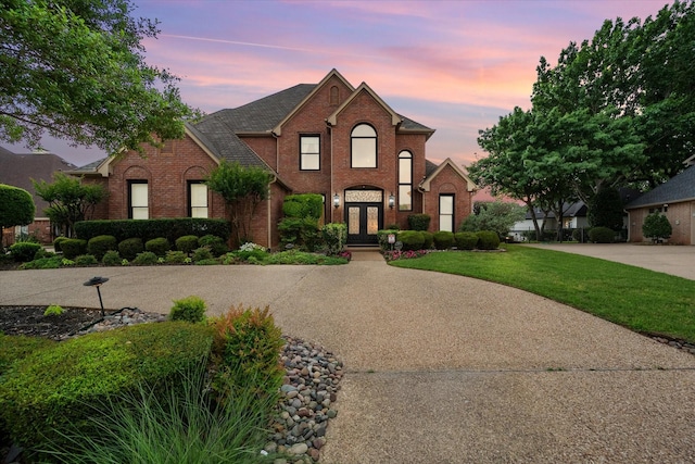 719 Morningside Dr, Mansfield, TX 76063 - traditional-style home featuring french doors, brick siding, and a front lawn