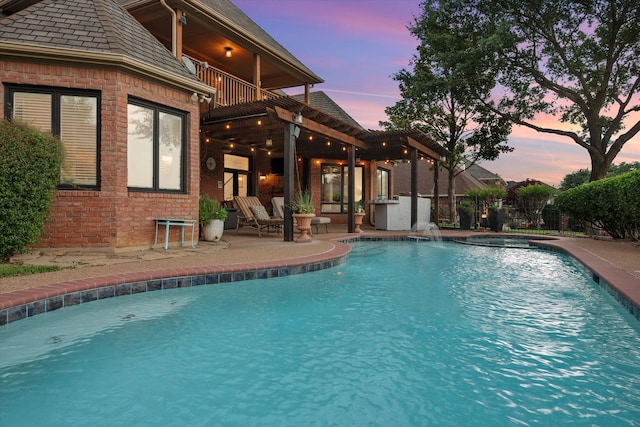 719 Morningside Dr, Mansfield, TX 76063 - pool at dusk featuring a patio area and an in-ground hot tub