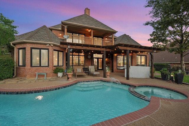 719 Morningside Dr, Mansfield, TX 76063 - back of property with a patio area, a balcony, brick siding, a pool with connected hot tub, and a chimney