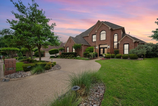 719 Morningside Dr, Mansfield, TX 76063 - traditional-style house featuring brick siding, curved driveway, and a lawn