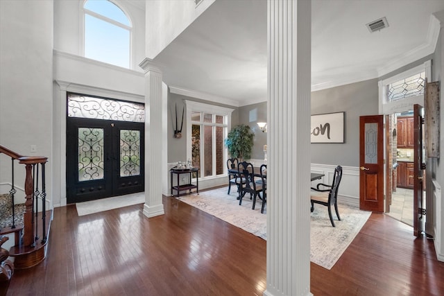 719 Morningside Dr, Mansfield, TX 76063 - entrance foyer with ornate columns, hardwood / wood-style flooring, french doors, crown molding, and a wainscoted wall