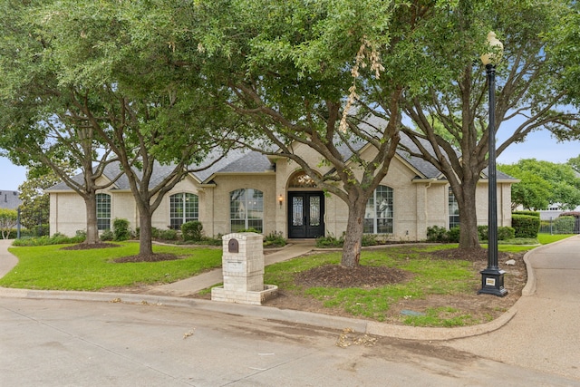 6 Trailside Ct, Mansfield, TX 76063 - view of front of house with french doors, a front lawn, and a shingled roof