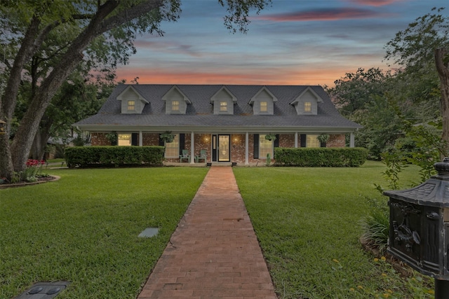 209 Shenandoah Dr, Euless, TX 76039 - cape cod-style house featuring covered porch, a front lawn, and brick siding