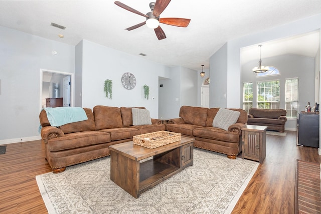 7037 Longo Dr, The Colony, TX 75056 - living room with wood finished floors, ceiling fan, vaulted ceiling, a chandelier, and baseboards