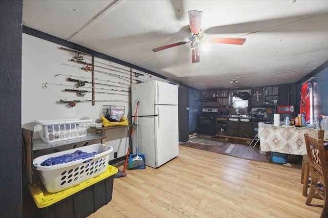 17128 County Road 3322, Frost, TX 76641 - kitchen with freestanding refrigerator, wood finished floors, electric stove, and ceiling fan