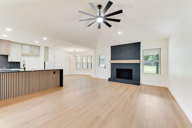 800 Shady Ln N, Keller, TX 76248 - unfurnished living room featuring a ceiling fan, a chandelier, light wood-style flooring, a fireplace, and baseboards