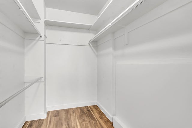 3883 Turtle Creek Blvd Unit 204, Dallas, TX 75219 - walk in closet featuring wood finished floors