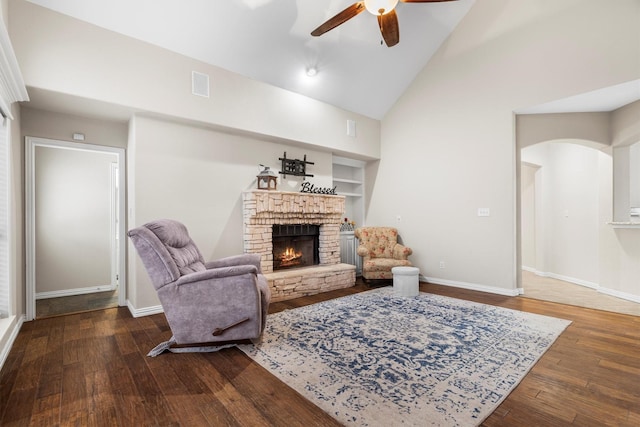 416 Bronco Cir, Shady Shores, TX 76208 - living area with a ceiling fan, a lit fireplace, wood finished floors, baseboards, and high vaulted ceiling