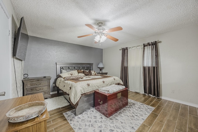 1808 Tameria Dr, Irving, TX 75060 - bedroom with wood finished floors, a textured ceiling, a ceiling fan, baseboards, and a textured wall