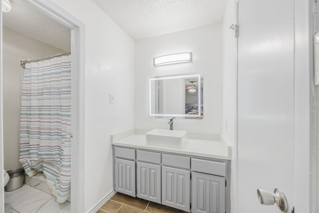 1808 Tameria Dr, Irving, TX 75060 - bathroom featuring a textured ceiling, vanity, and baseboards