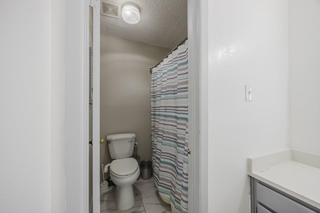 1808 Tameria Dr, Irving, TX 75060 - full bath with toilet, a textured ceiling, vanity, marble look tiles, and a shower with curtain