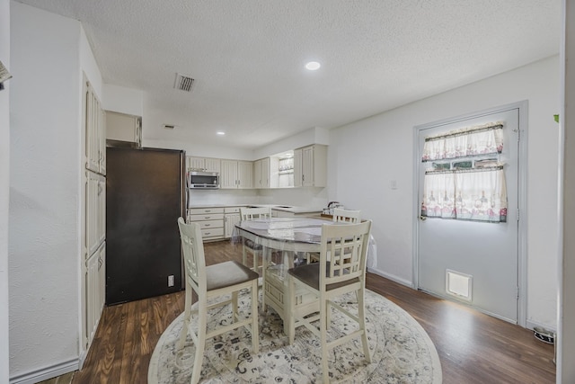 1808 Tameria Dr, Irving, TX 75060 - dining room with dark wood-type flooring, a textured ceiling, and recessed lighting