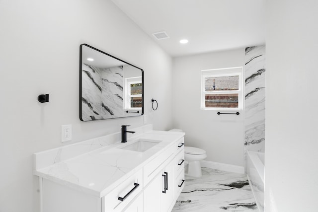 1409 Milner Rd, Irving, TX 75061 - bathroom with vanity, toilet, marble finish floors, recessed lighting, and baseboards