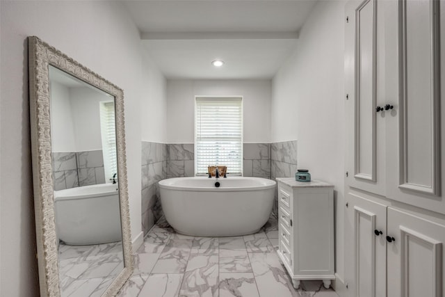 2208 Turtle Creek Dr, Sherman, TX 75092 - full bathroom with marble finish floors, wainscoting, a freestanding tub, tile walls, and recessed lighting