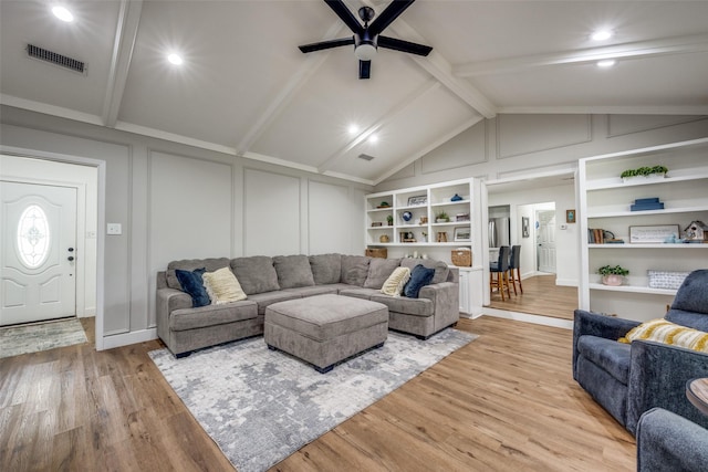 2208 Turtle Creek Dr, Sherman, TX 75092 - living room with a decorative wall, a ceiling fan, and light wood-style flooring