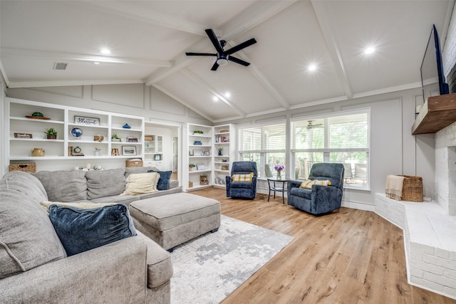 2208 Turtle Creek Dr, Sherman, TX 75092 - living room featuring light wood-type flooring, ceiling fan, built in shelves, and a brick fireplace