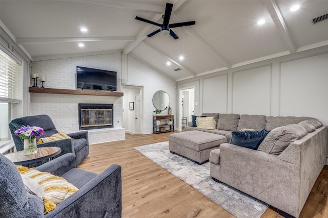 2208 Turtle Creek Dr, Sherman, TX 75092 - living room with a decorative wall, ceiling fan, wood finished floors, and a fireplace