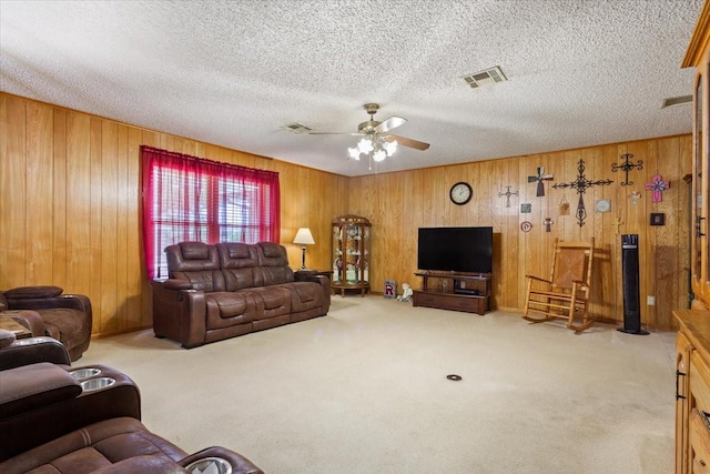 109 Hilltop St, Riesel, TX 76682 - carpeted living area featuring a ceiling fan, wooden walls, and a textured ceiling