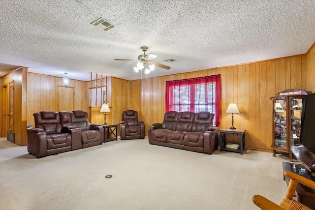 109 Hilltop St, Riesel, TX 76682 - carpeted living room with ceiling fan, wooden walls, and a textured ceiling