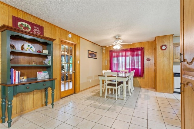 109 Hilltop St, Riesel, TX 76682 - dining room featuring wooden walls, light tile patterned floors, ornamental molding, a ceiling fan, and a textured ceiling