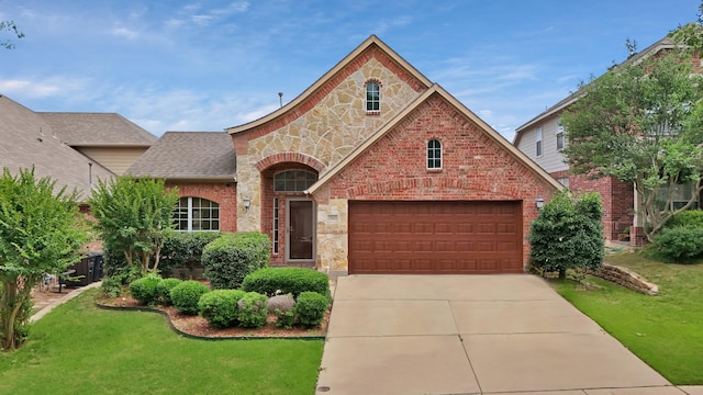 760 Red Elm Ln, Fort Worth, TX 76131 - french country inspired facade featuring stone siding, driveway, a front yard, and brick siding