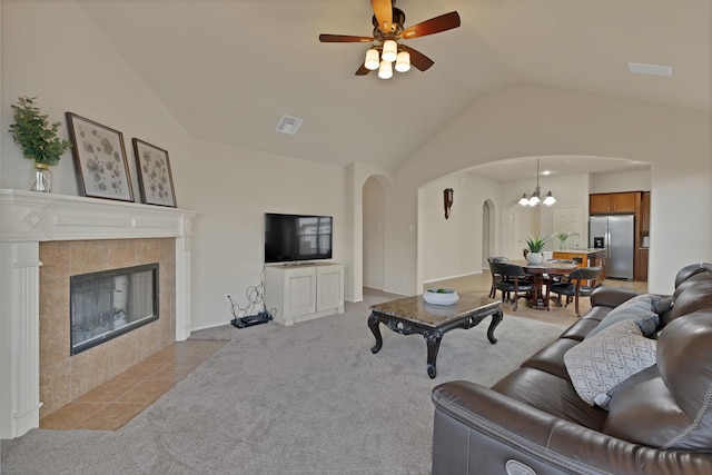 760 Red Elm Ln, Fort Worth, TX 76131 - living room featuring arched walkways, lofted ceiling, light carpet, ceiling fan, and a chandelier