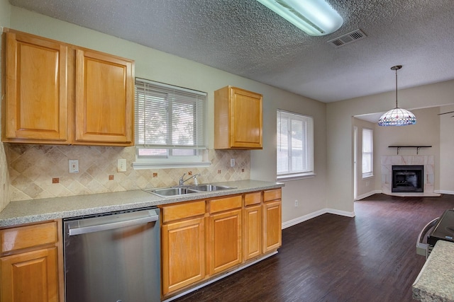 6729 Windwillow Dr, Fort Worth, TX 76137 - kitchen with dishwasher, a sink, dark wood-style flooring, healthy amount of natural light, and a textured ceiling