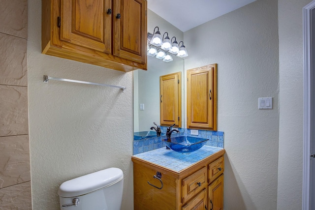 6729 Windwillow Dr, Fort Worth, TX 76137 - bathroom featuring vanity, toilet, and a textured wall
