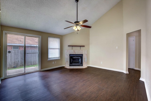 6729 Windwillow Dr, Fort Worth, TX 76137 - unfurnished living room with a ceiling fan, lofted ceiling, a textured ceiling, wood finished floors, and a tile fireplace