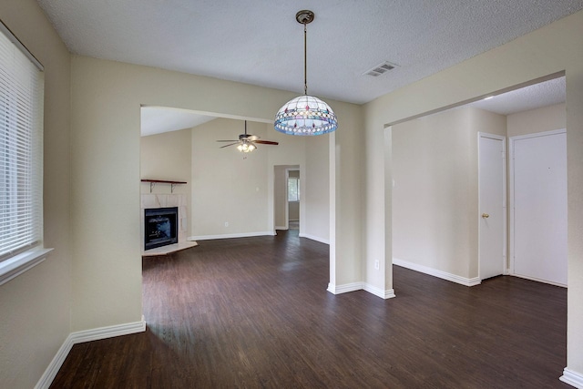 6729 Windwillow Dr, Fort Worth, TX 76137 - unfurnished living room with wood finished floors, ceiling fan, a tile fireplace, and baseboards