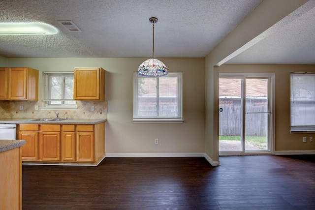 6729 Windwillow Dr, Fort Worth, TX 76137 - kitchen with a textured ceiling, dark wood-style floors, backsplash, baseboards, and dishwasher