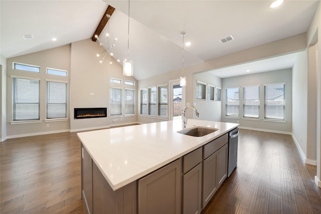 3493 Hollow Pine Dr, Frisco, TX 75033 - kitchen with open floor plan, a sink, dark wood-style floors, stainless steel dishwasher, and beam ceiling
