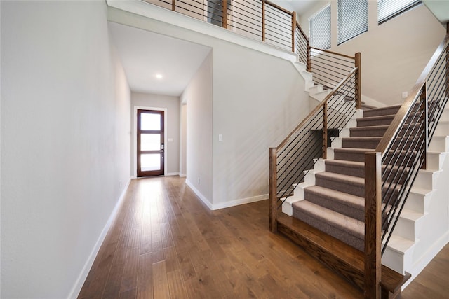3493 Hollow Pine Dr, Frisco, TX 75033 - stairway featuring baseboards, wood finished floors, and a towering ceiling