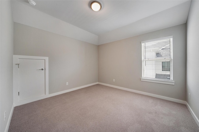 3493 Hollow Pine Dr, Frisco, TX 75033 - spare room with light colored carpet, baseboards, lofted ceiling, and a smoke detector
