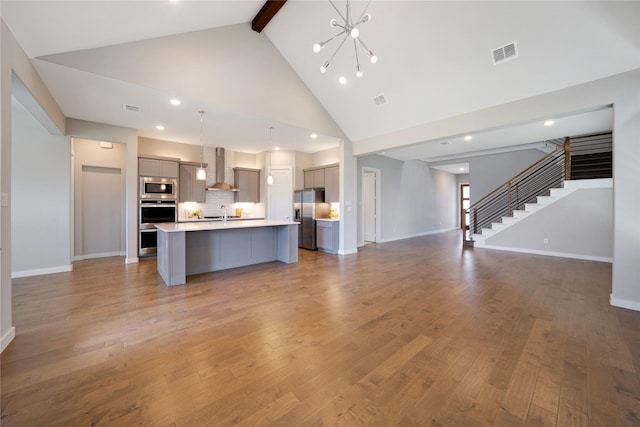 3493 Hollow Pine Dr, Frisco, TX 75033 - unfurnished living room with beam ceiling, stairs, baseboards, high vaulted ceiling, and wood finished floors