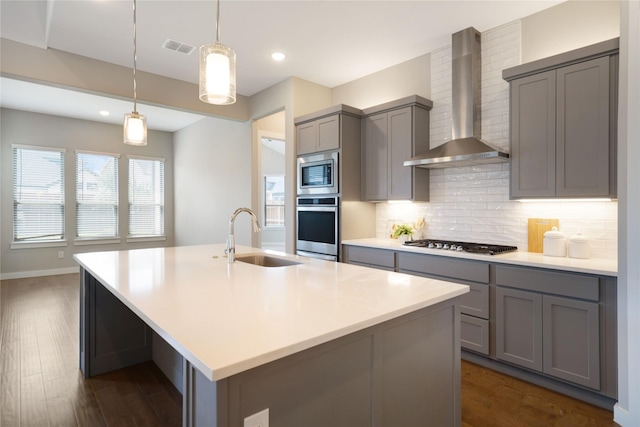 3493 Hollow Pine Dr, Frisco, TX 75033 - kitchen with wall chimney exhaust hood, a sink, appliances with stainless steel finishes, gray cabinets, and recessed lighting