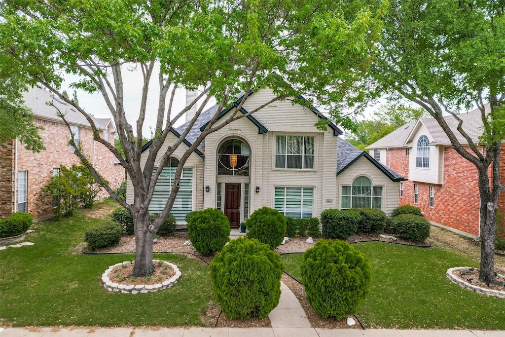 5916 Broadmoor Dr, Plano, TX 75093 - traditional-style home featuring a front lawn and brick siding