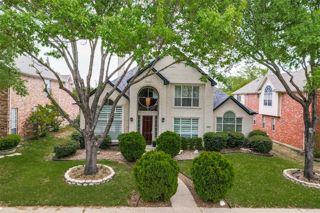 5916 Broadmoor Dr, Plano, TX 75093 - traditional-style home featuring a front lawn and brick siding