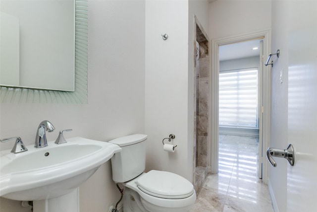 5916 Broadmoor Dr, Plano, TX 75093 - bathroom with a sink, toilet, marble finish floors, and baseboards