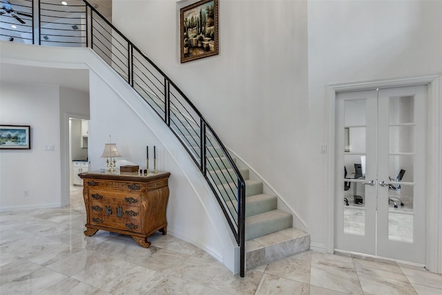 5916 Broadmoor Dr, Plano, TX 75093 - staircase featuring a high ceiling, marble tiled flooring, baseboards, and french doors