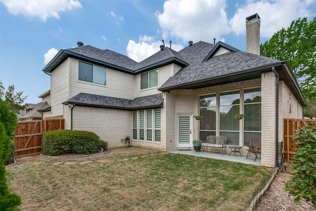 5916 Broadmoor Dr, Plano, TX 75093 - back of house with a patio area, a shingled roof, brick siding, and a chimney