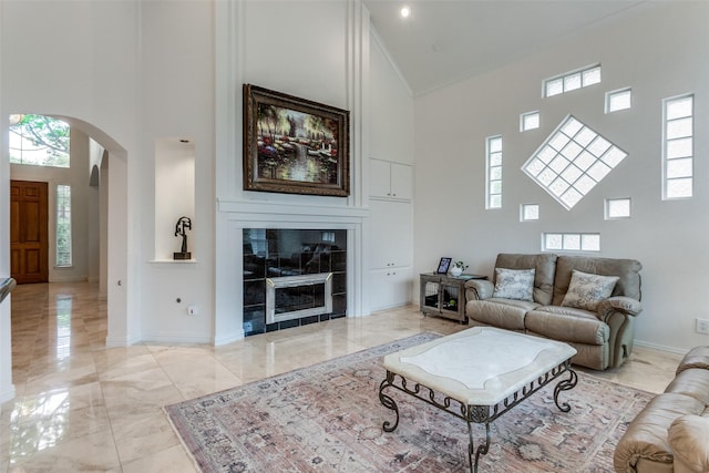 5916 Broadmoor Dr, Plano, TX 75093 - living area with a high ceiling, light marble finish flooring, arched walkways, baseboards, and ornamental molding