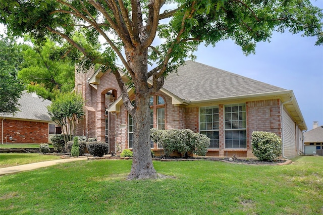 1535 Eagle Nest Pass, Lewisville, TX 75077 - view of front of house with brick siding, roof with shingles, and a front lawn
